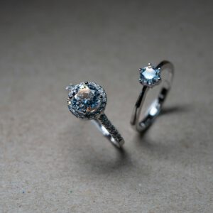 Close-up image of luxury diamond engagement rings on a neutral background.