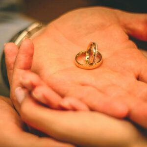 A close-up shot of wedding rings held in the palms, conveying love and commitment.